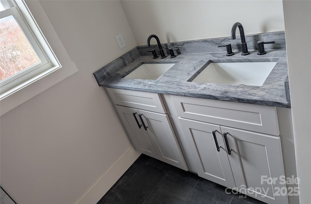 full bath with double vanity, tile patterned flooring, and a sink