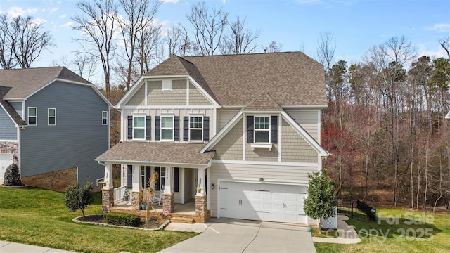 craftsman house with board and batten siding, a porch, concrete driveway, and roof with shingles