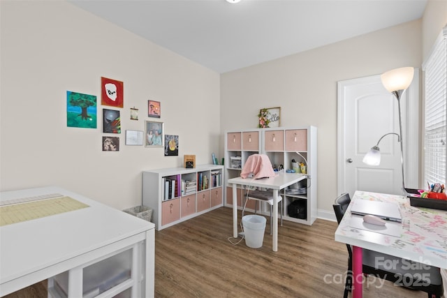 bedroom featuring wood finished floors and baseboards