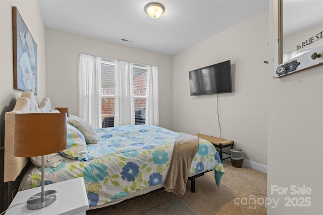 bedroom featuring carpet flooring, visible vents, and baseboards