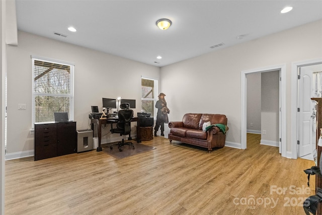 home office with recessed lighting, baseboards, visible vents, and light wood finished floors