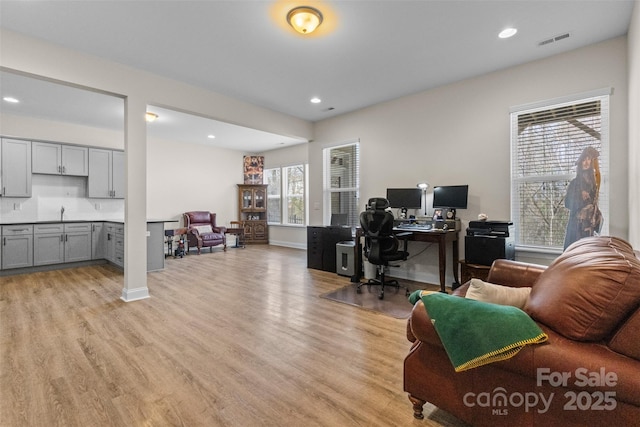 office with light wood-type flooring, baseboards, visible vents, and recessed lighting