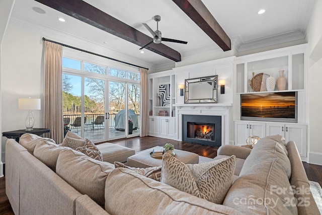 living room featuring a lit fireplace, ornamental molding, dark wood-style flooring, and beamed ceiling