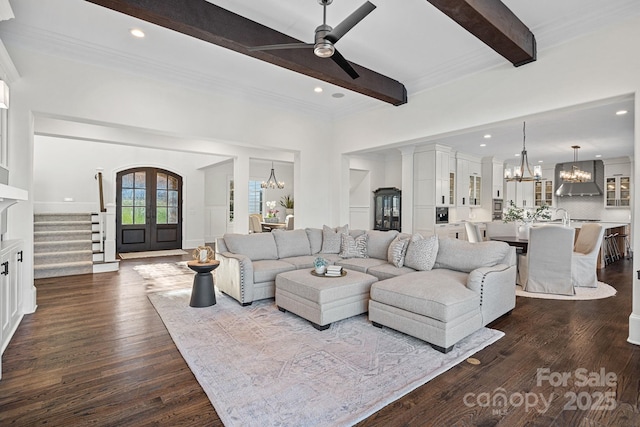 living area with stairway, wood finished floors, beam ceiling, and french doors