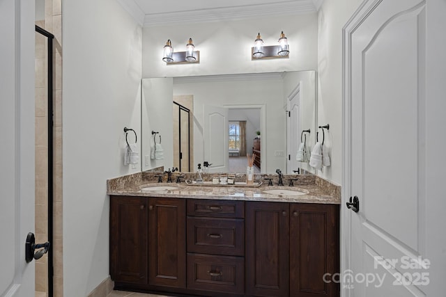 bathroom with crown molding, a sink, a shower stall, and double vanity