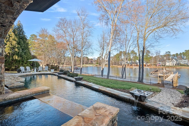 dock area with a water view, fence, a fenced in pool, and a patio