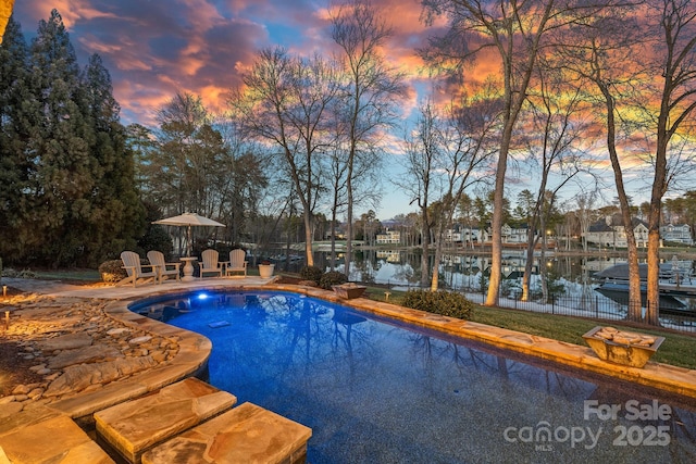 view of pool featuring a water view and a fenced in pool