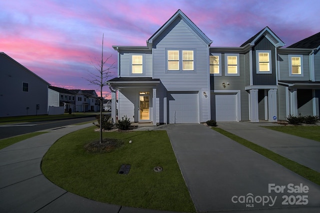 view of front of house with a garage and a yard