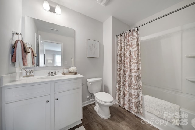 full bathroom featuring toilet, vanity, shower / bathtub combination with curtain, and hardwood / wood-style floors