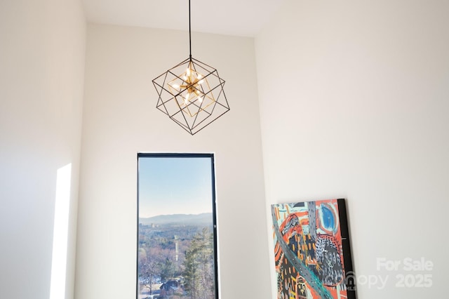 interior details featuring an inviting chandelier