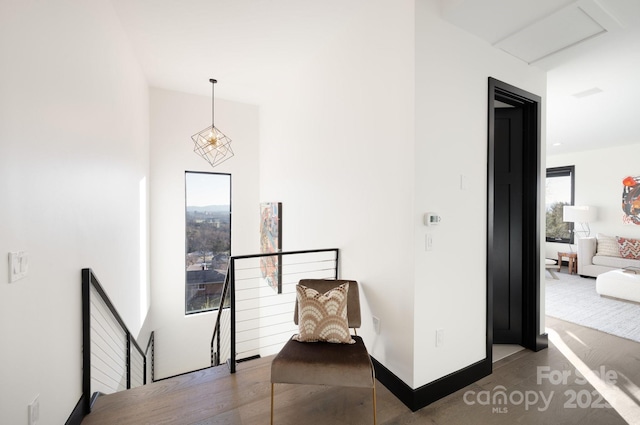 corridor with baseboards and an upstairs landing