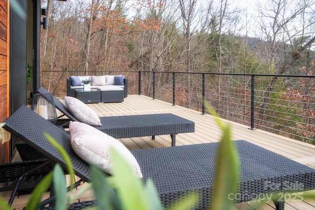 wooden terrace with outdoor lounge area