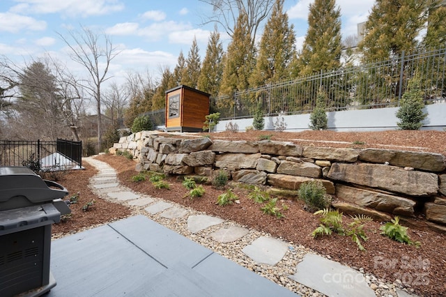 view of yard featuring a patio, a water view, and fence