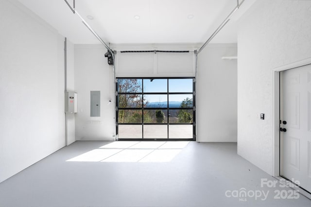 spare room featuring electric panel and concrete flooring