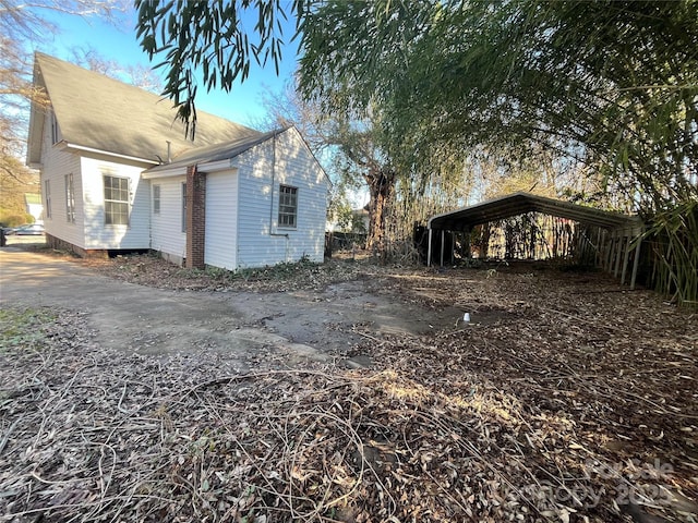 view of property exterior featuring a carport