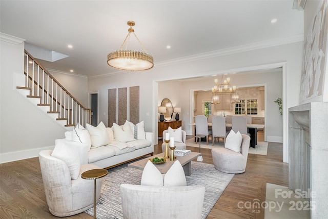 living room featuring an inviting chandelier, ornamental molding, and wood-type flooring