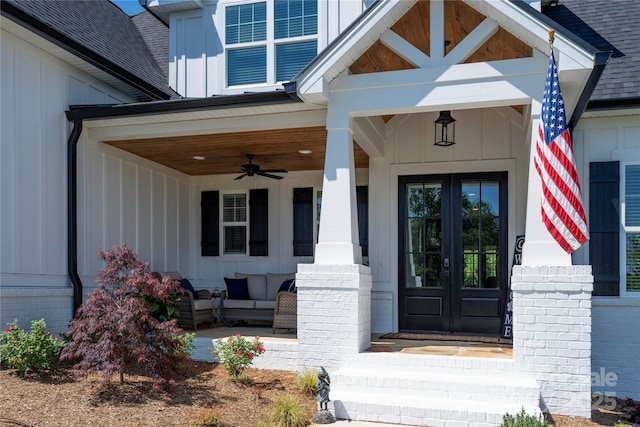 property entrance featuring ceiling fan, roof with shingles, french doors, and board and batten siding