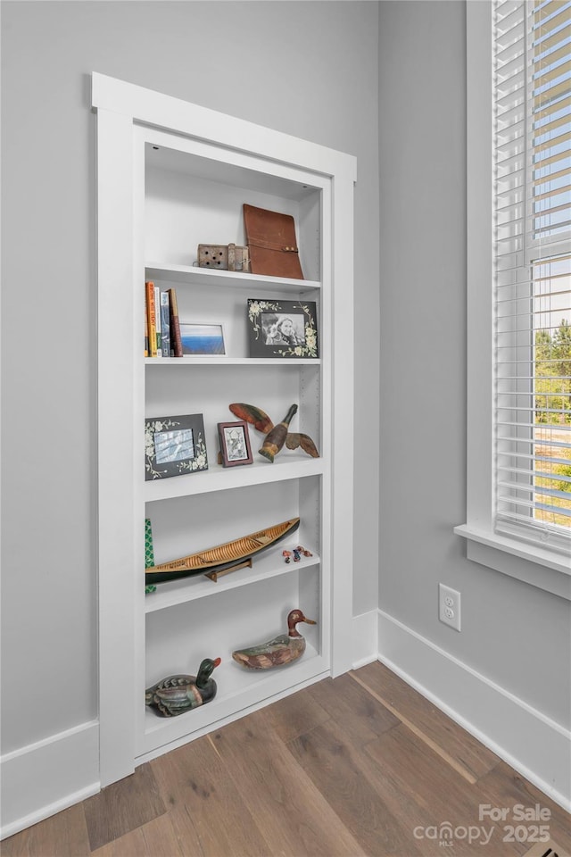 room details with baseboards and wood finished floors