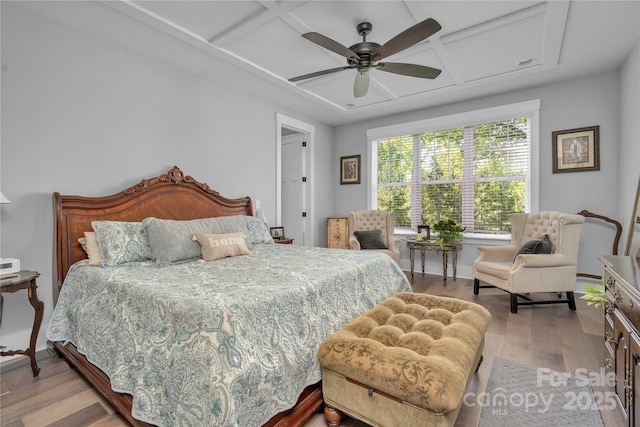 bedroom with ceiling fan, coffered ceiling, wood finished floors, and baseboards