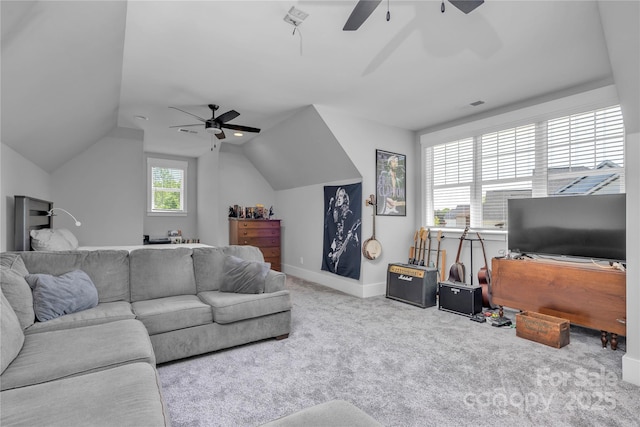 living area featuring lofted ceiling, carpet flooring, ceiling fan, and baseboards