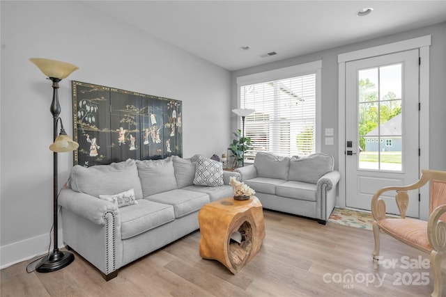 living room with recessed lighting, visible vents, and light wood-style flooring