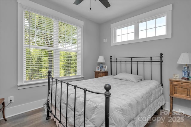 bedroom with wood finished floors, a ceiling fan, and baseboards