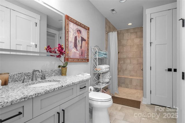 full bath with visible vents, toilet, a tile shower, vanity, and recessed lighting