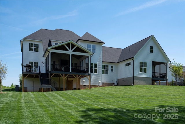 back of property with a shingled roof, a lawn, a sunroom, crawl space, and stairs