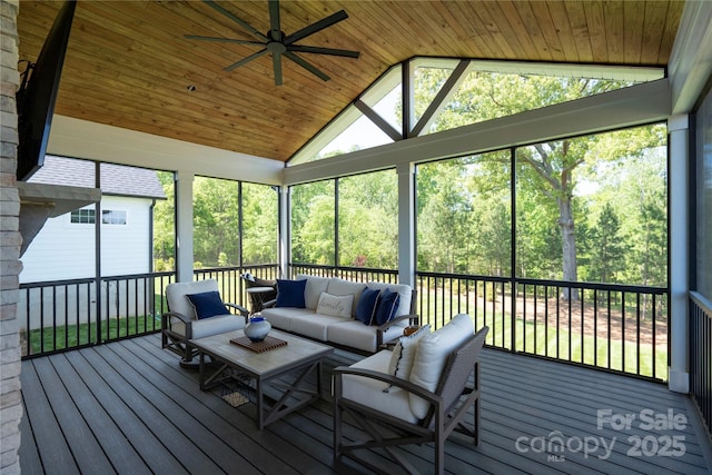 sunroom / solarium featuring vaulted ceiling, ceiling fan, and wood ceiling