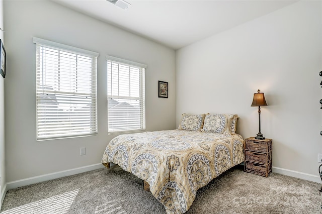 carpeted bedroom featuring visible vents and baseboards