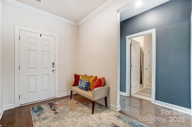 foyer with ornamental molding, dark wood-style flooring, and baseboards