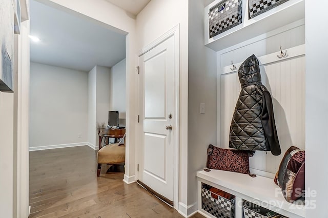 mudroom featuring baseboards and wood finished floors