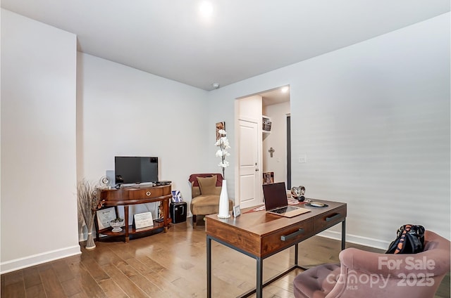 home office with wood finished floors and baseboards