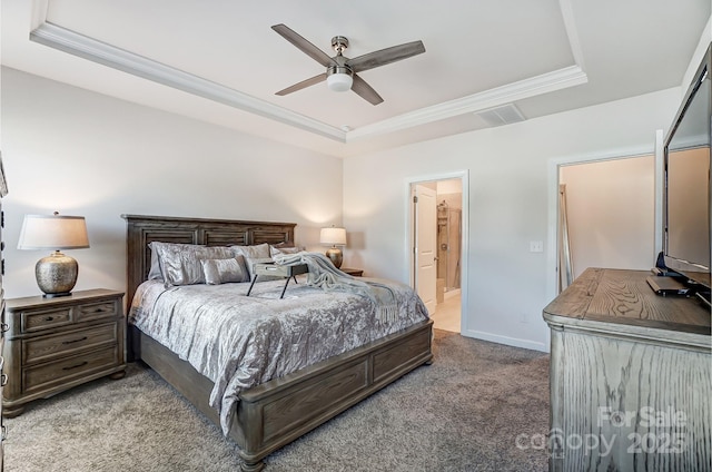 carpeted bedroom featuring a tray ceiling, crown molding, visible vents, connected bathroom, and baseboards