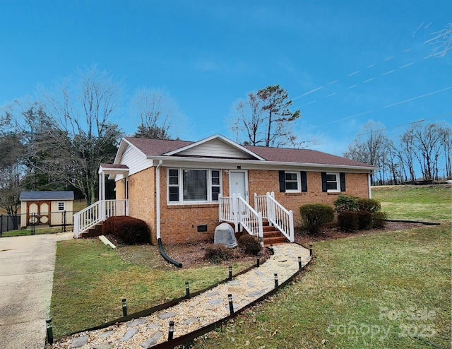 single story home featuring a storage shed and a front lawn