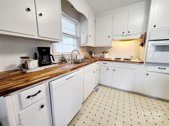 kitchen featuring butcher block countertops, sink, white cabinets, and white appliances