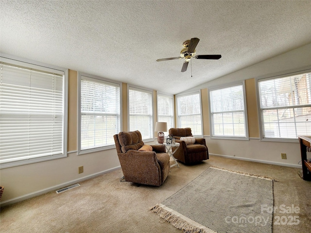 interior space with a wealth of natural light, vaulted ceiling, and ceiling fan