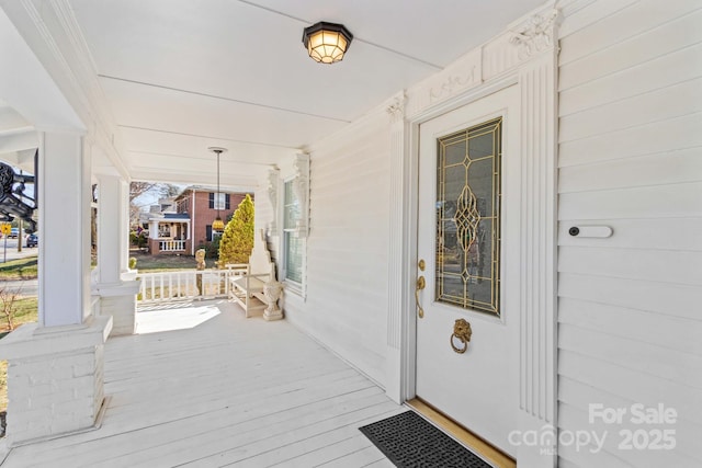 view of exterior entry with a porch