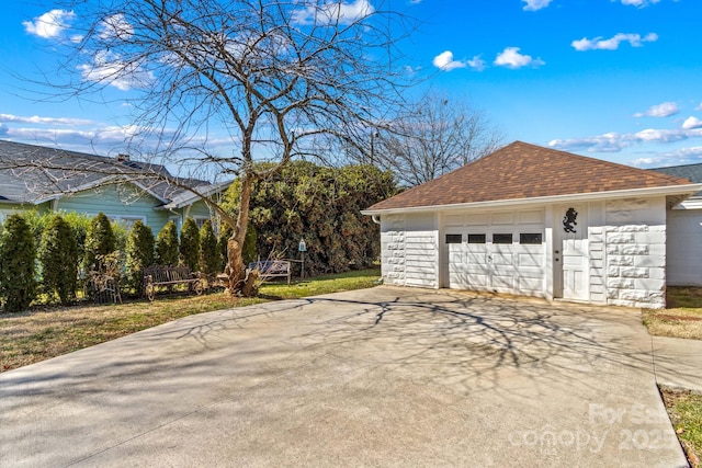 garage with concrete driveway