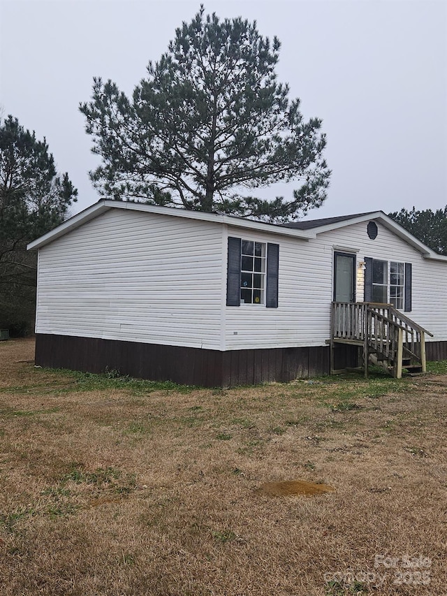 view of side of home featuring a lawn