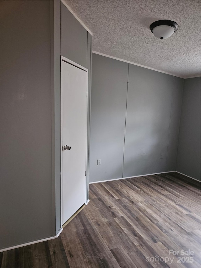 unfurnished bedroom with ornamental molding, hardwood / wood-style floors, and a textured ceiling