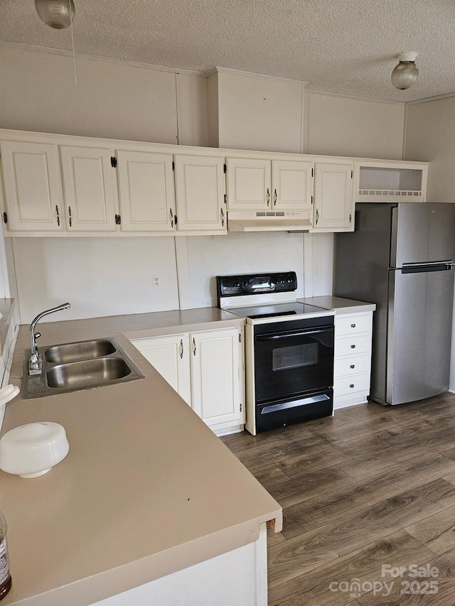 kitchen with white cabinetry, sink, range with electric stovetop, and stainless steel fridge