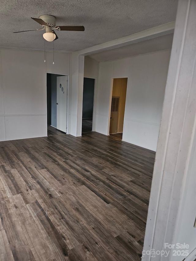 spare room with ceiling fan, dark hardwood / wood-style floors, and a textured ceiling