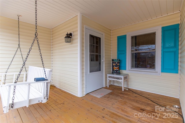 view of exterior entry featuring covered porch