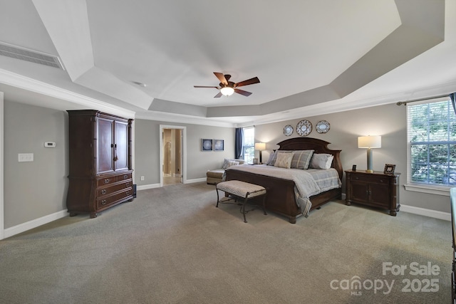 carpeted bedroom featuring a raised ceiling, crown molding, and ceiling fan