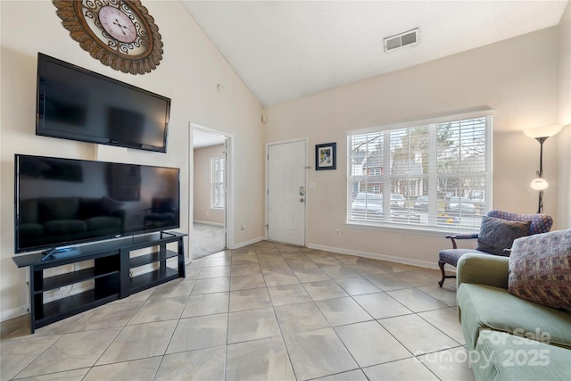 living room with high vaulted ceiling and light tile patterned floors