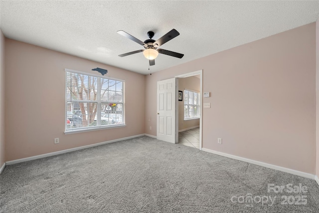 unfurnished bedroom featuring ceiling fan, light colored carpet, and a textured ceiling