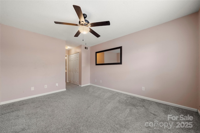 carpeted spare room with ceiling fan