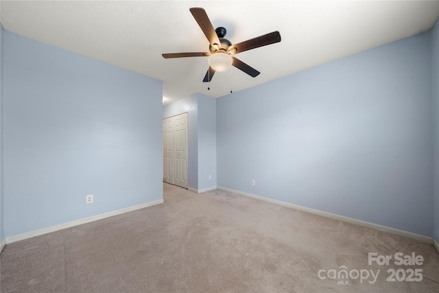 spare room with light carpet and ceiling fan