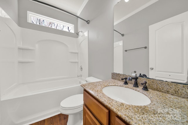 bathroom featuring shower / washtub combination, toilet, ornamental molding, wood finished floors, and vanity